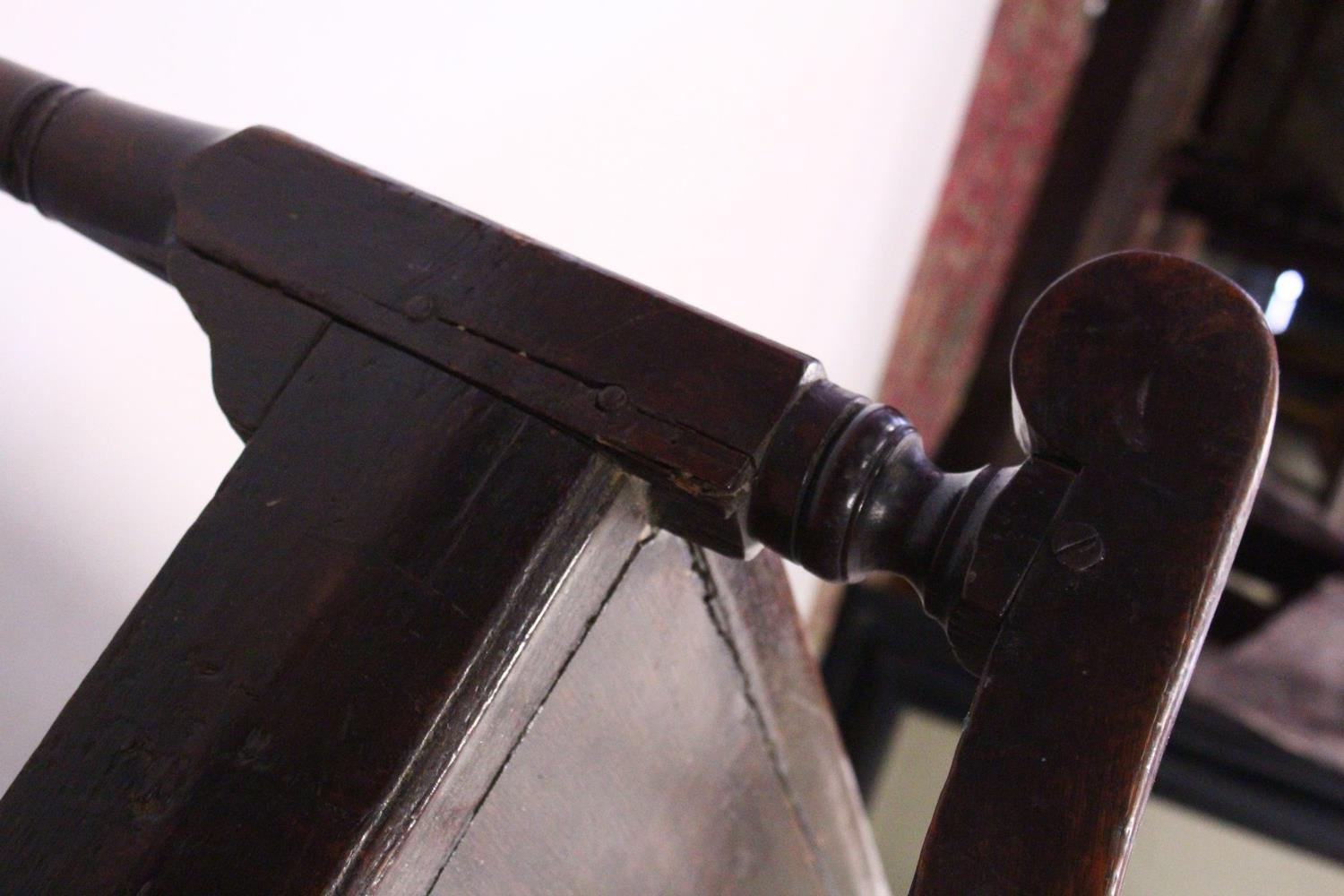 AN 18TH CENTURY OAK SETTLE, with a four panel back, curving arms, solid seat, on cabriole front - Image 4 of 13