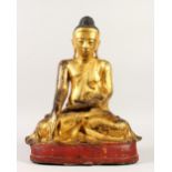 A LARGE GILT BRONZE FIGURE OF A BUDDHA, in a seated position, on a painted base. 44cms high.