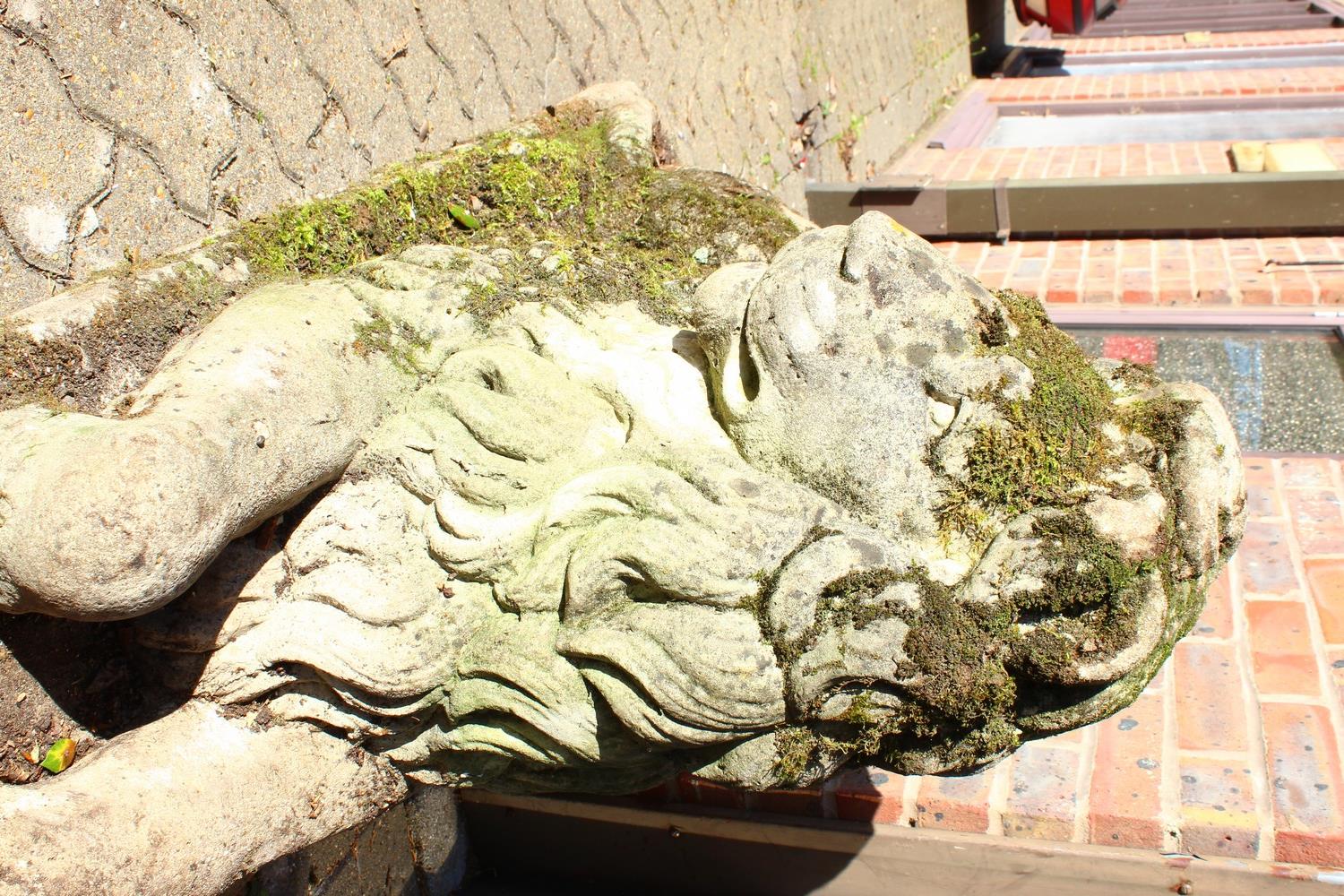 AN IMPOSING PAIR OF RECONSTITUTED STONE LIONS, in a recumbent pose, each looking to the side. 128cms - Image 7 of 10