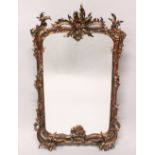 A DECORATIVE ROCOCO STYLE PIER MIRROR, with ornate frame. 112cms high x 65cms wide.