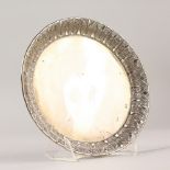 A CONTINENTAL SILVER WAITER with leaf border. 17cms diameter.