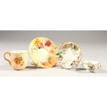 A MINIATURE FLOWER ENCRUSTED CUP AND SAUCER and A ROYAL WORCESTER CUP AND SAUCER.