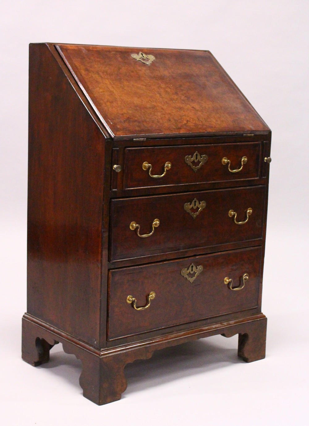 A GEORGE III DESIGN "PLUM PUDDING" MAHOGANY SMALL BUREAU, the drop flap opening to reveal