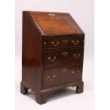 A GEORGE III DESIGN "PLUM PUDDING" MAHOGANY SMALL BUREAU, the drop flap opening to reveal