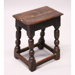 A 17TH/18TH CENTURY OAK JOINT STOOL, with a moulded top, Arcadian carved frieze, on baluster