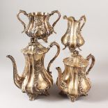 A VICTORIAN FOUR PIECE SILVER TEA SET comprising teapot, hot water jug, sugar basin and milk jug.