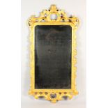A MID 18TH CENTURY GILT FRAMED PIER MIRROR, with early mirror plate, in a pierced and carved