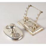 A PEN HOLDER AND BLOTTER inset with coins.