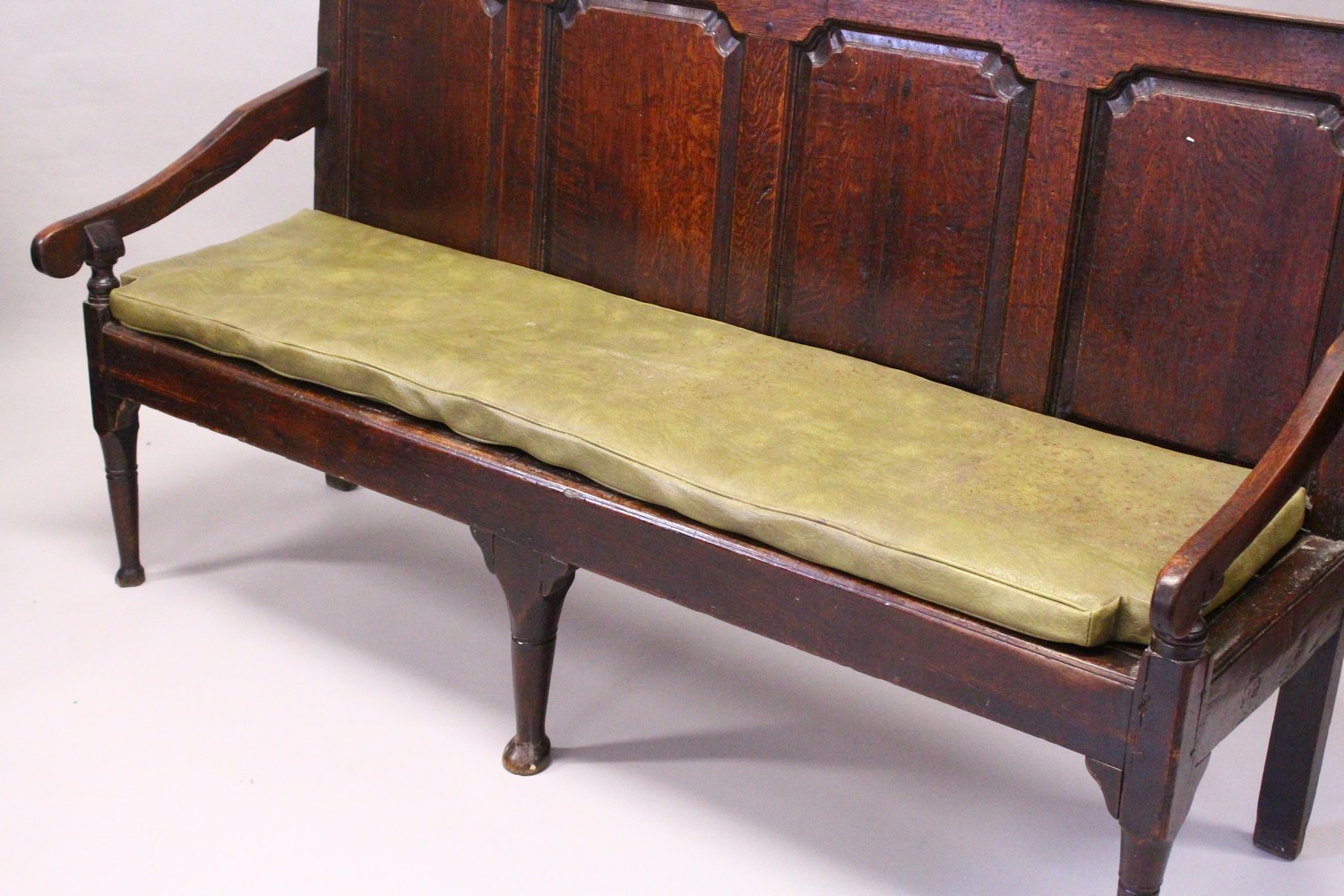 AN 18TH CENTURY OAK SETTLE, with a four panel back, curving arms, solid seat, on cabriole front - Image 12 of 13