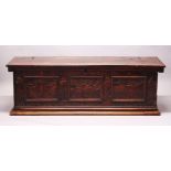 AN 18TH CENTURY ITALIAN STAINED PINE CASSONE, plain plank top, with carved and pen work decorated