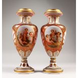 A GOOD LARGE PAIR OF BOHEMIAN RUBY GLASS VASES, with gilt and white enamel decoration, painted