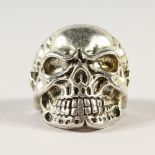 A SILVER SKULL RING.