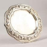 A CONTINENTAL SILVER WAITER, the edge with fruit. 15cms diameter.