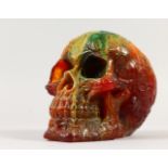 AN AMBER STYLE MODEL OF A SKULL. 6.5ins.