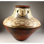 A GOOD VERY LARGE PERUVIAN SHIPIBO CULTURE CIRCULAR TWO-TIER POT, the side with a face. 64cms high x