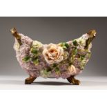 A CONTINENTAL TWO-HANDLED BOAT SHAPED RUSTIC BOWL, encrusted with flowers. 26cms long x 16cms high.