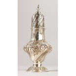 A VICTORIAN WRYTHEN FLUTED SUGAR SIFTER with repousse decoration. 18.5cms high. London 1891.