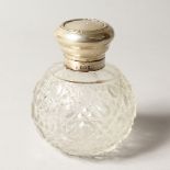 A SILVER TOP CUT GLASS SCENT BOTTLE.