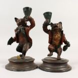 A PAIR OF COLD PAINTED BRONZE CANDLESTICKS, modelled as a fox and a bear. 18cms high.