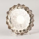 A VICTORIAN ENGRAVED WAITER with shell border. 17cms diameter. London 1840. Makers: Joseph and