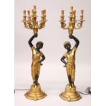 A PAIR OF DECORATIVE BLACKAMOOR CANDELABRA, on shaped circular bases. 120cms high.