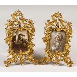 A PAIR OF FRENCH GILT BRONZE EASEL PHOTOGRAPH FRAMES with 1920's photograph. 28cms high.