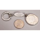 A KENNEDY HALF DOLLAR, QUARTER DOLLAR AND KEY RING.