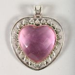 A SILVER HEART SHAPED PENDANT, with pink stone.