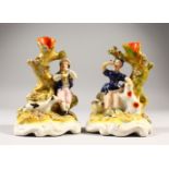 A PAIR OF STAFFORDSHIRE FLOWER ENCRUSTED VASE, a girl with a lamb, a boy with a dog. 14cms high.