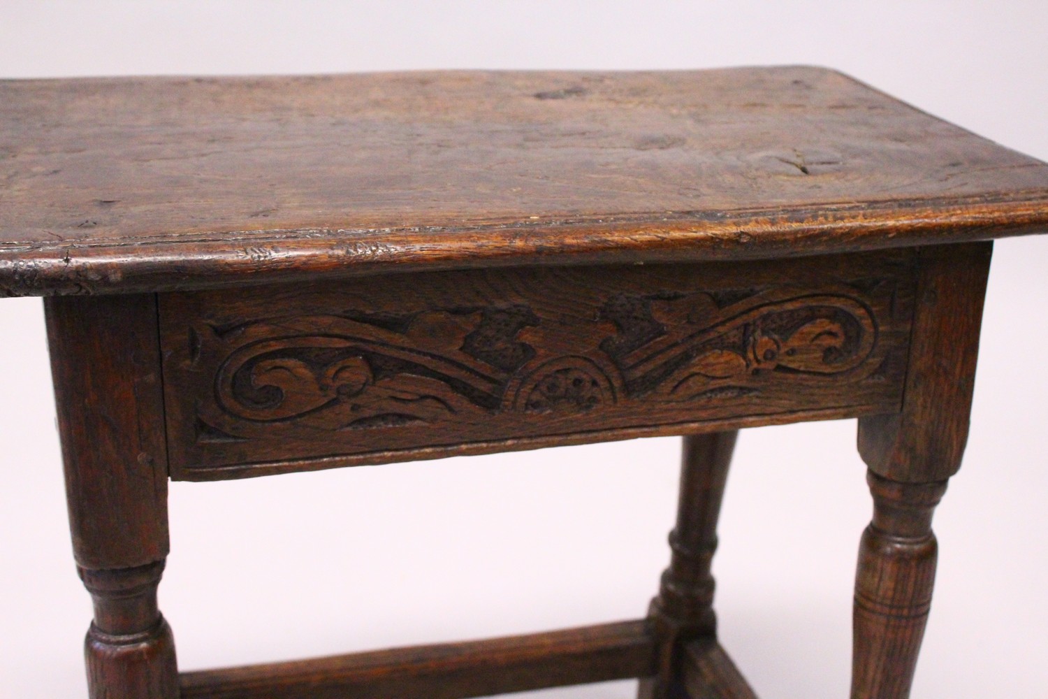 AN 18TH CENTURY OAK JOINT STOOL, with moulded top, carved frieze on turned legs united by - Image 2 of 4