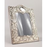 A SILVER UPRIGHT PHOTOGRAPH FRAME. 29cms high x 20cms wide.