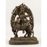 AN EASTERN BRONZE GROUP, depicting a god seated on a horse. 30cms high.