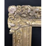 Early 18th Century French School. A Louis XIV Carved Giltwood Oak Frame with swept centres and