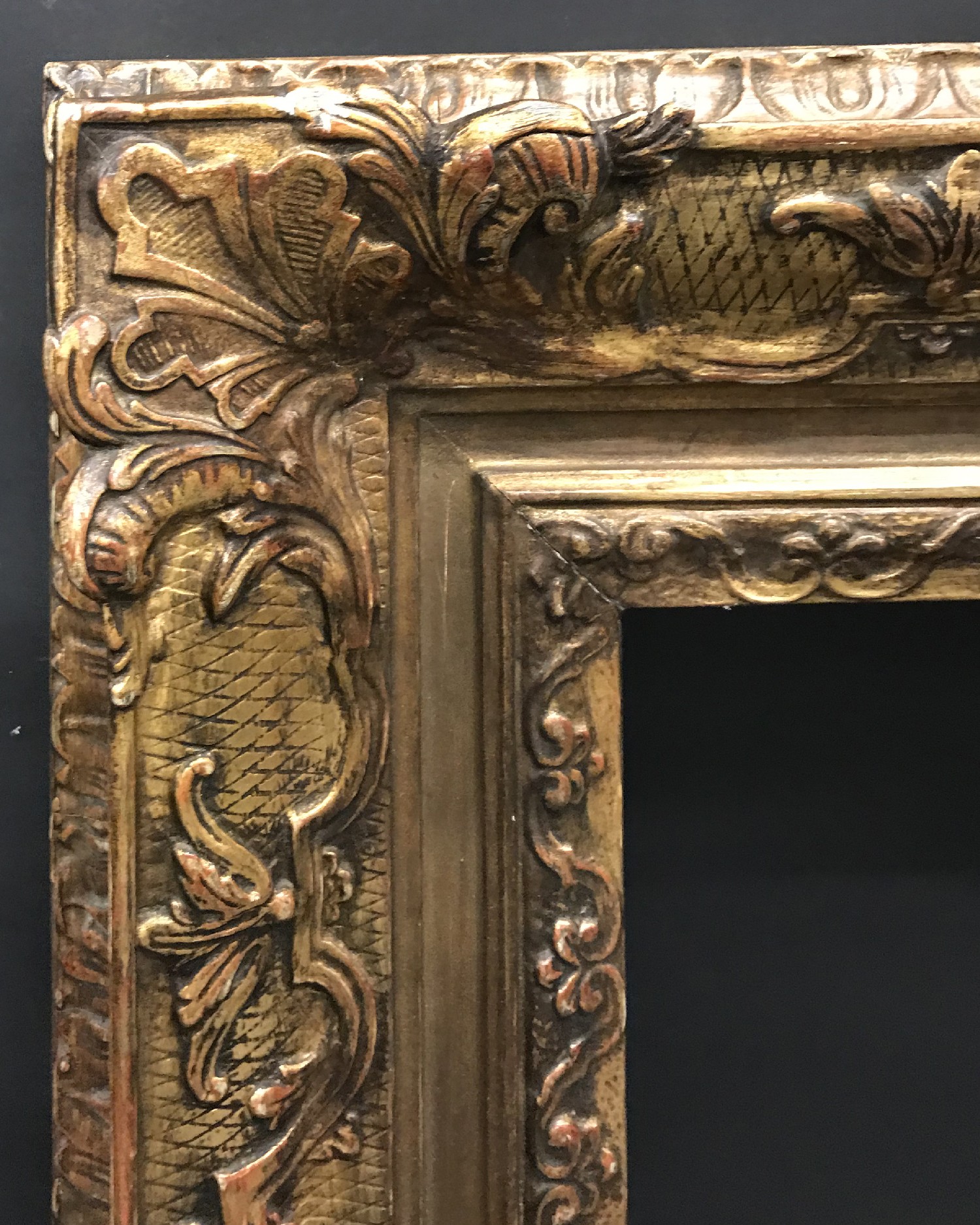 Early 20th Century Continental School. A Gilt Composition Frame, with Swept Centres and Corners,