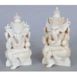 A NEAR PAIR OF EARLY 20TH CENTURY INDIAN IVORY FIGURES OF GANESH, the elephant-headed God seated