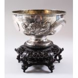 A GOOD JAPANESE MEIJI PERIOD SOLID SILVER DRAGON BOWL & HARDWOOD STAND, the bowl with pressed relief