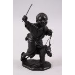 A JAPANESE MEIJI PERIOD BRONZE OKIMONO OF A BOY ON A HOBBY HORSE, in a moving stance with the