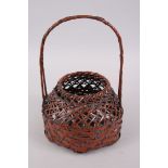 A FINE JAPANESE MEIJI PERIOD WOVEN BAMBOO IKEBANA BASKET ARTIST SIGNED, the basket with a woven