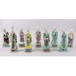 A SET OF 9 18TH CENTURY CHINESE FAMILLE VERTE PORCELAIN FIGURES OF IMMORTALS, each measuring