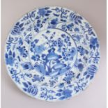 AN 18TH CENTURY CHINESE BLUE & WHITE PLATE, decorated with, flora and tree scenes, 35cm diameter.