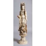 A LARGE MEIJI PERIOD JAPANESE IVORY OKIMONO OF KWANNON & A SEA DRAGON, she is modeled stood upon a