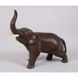 A JAPANESE MEIJI PERIOD BRONZE ELEPHANT OKIMONO, stood in a moving pose with his trunk aloft,