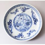 AN EARLY 18TH CENTURY CHINESE BLUE & WHITE PORCELAIN PLATE, decorated with an array of seasonal