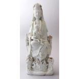 A 18TH / 19TH CENTURY CHINESE BLANC DE CHINE FIGURE OF GUANYIN WITH THREE BOYS, 38.5cm high X 14.5cm