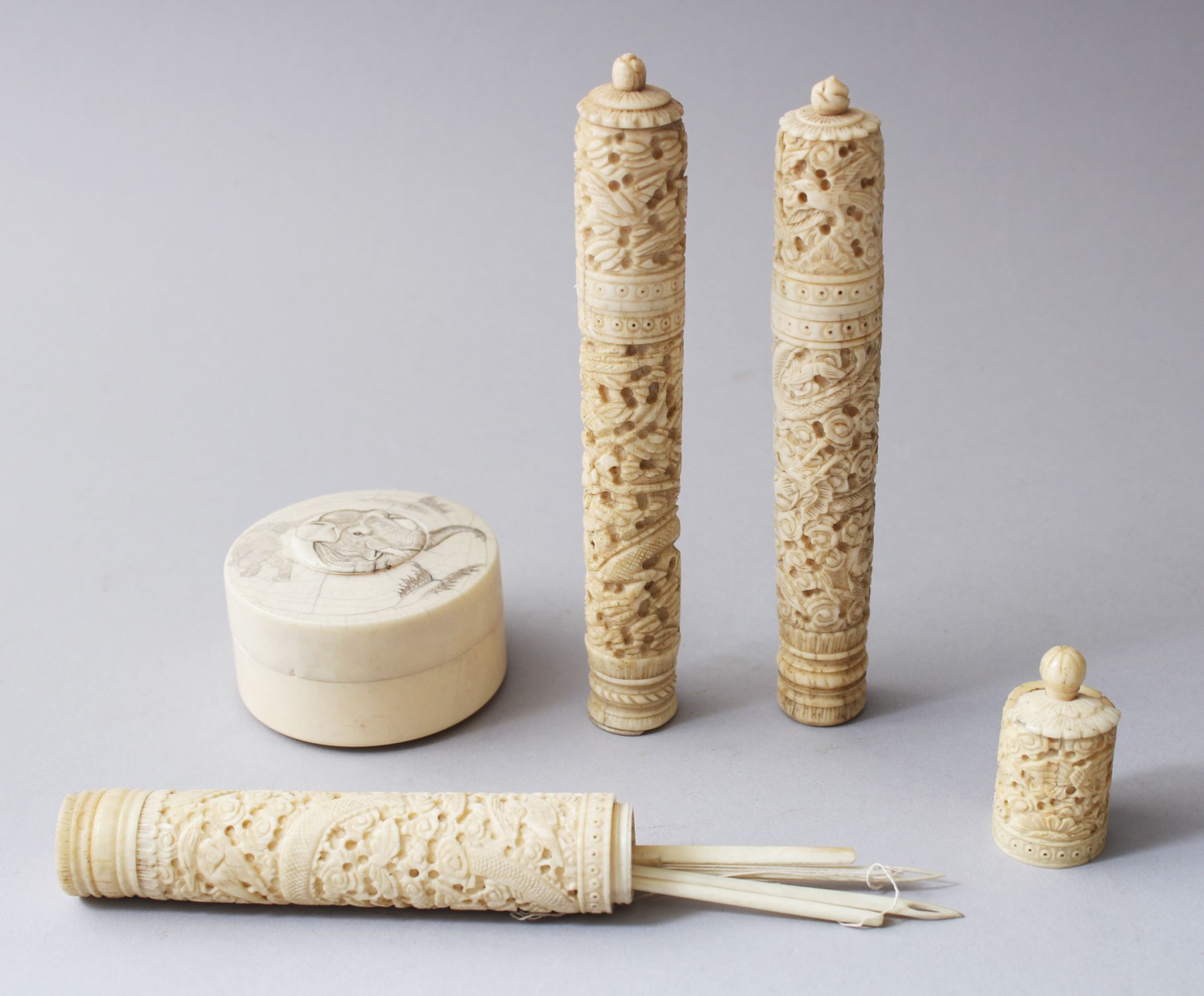 THREE 19TH CENTURY CHINESE CANTON NEEDLE / BODKIN CASES & CYLINDRICAL IVORY POT, each carved with