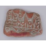 A 20TH CENTURY TIBETAN PRAYER STONE, of irregular form, the red pigmented surface engraved with a