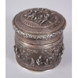 A GOOD 19TH CENTURY BURMESE SOLID SILVER CIRCULAR POT & LID, with high relief scenes of figures in