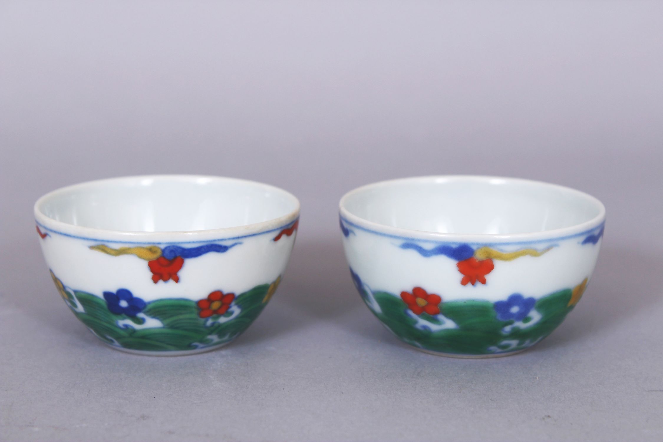 A SMALL PAIR OF CHINESE DOUCAI PORCELAIN WINE CUPS, each decorated with stylised waves bearing - Image 2 of 6