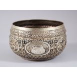 A GOOD 19TH CENTURY BURMESE SOLID SILVER BOWL, repousse decorated in high relief with five different