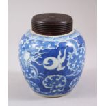 A 19TH CENTURY JAPANESE BLUE & WHITE GINGER JAR & COVER, decorated with a dragon amongst stylized